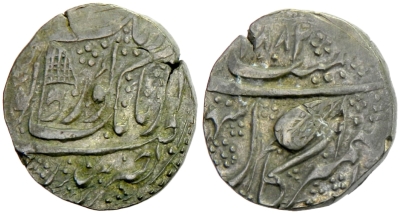 Kashmir Mint, VS1882 Rupee, Flag symbol
Akaal Sahai on the Rev.
http://db.stevealbum.com/php/lot_auc.php?site=2&sale=18&lot=1620&lang=1&cust=0
Steve Album Auctions 18 : Lot 1620
SIKH EMPIRE: AR rupee (11.05g), Kashmir, VS1882, KM-46.8, Herrli-06.15.04, banner in obverse field, EF, ex KM plate specimen. 
This is an very rare variant with the banner.
