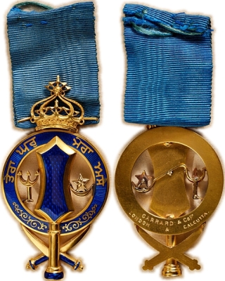 Patiala, Nishan-i-Phul, Badge, Gold and Enamel
Auktionshaus Andreas Thies eK
Auction 74, Lot No. 33

Gold and enamels, with ribbon. On the back engraved maker's inscription: "GARRARD & CO. LTD / LONDON - CALCUTTA".
The bright blue translucent enamel with a finely guilloched background. A splendid example of the finest jeweller's quality made by the British court jeweller, who produced almost all the decorations for the legendary Maharajah of Patiala, Bhupendra Singh.

Without collar chain version of the Order. Badge worn with a ribbon.

